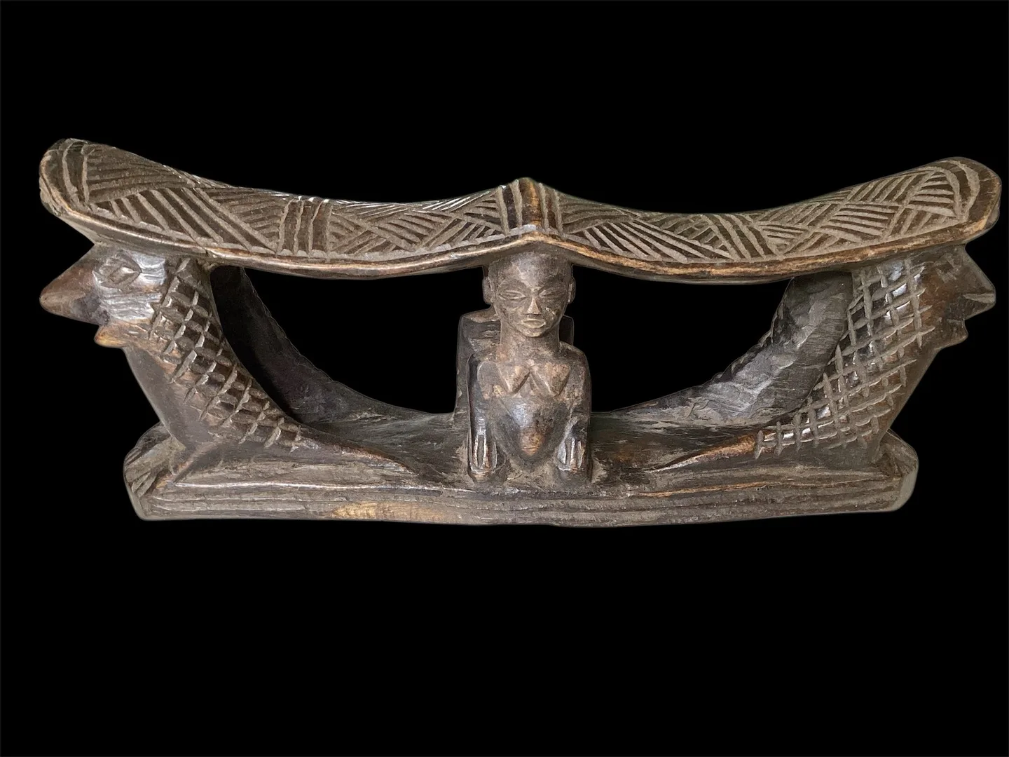 Double wooden headrest in people Chokwe (Konga), with traditional rytinami crocodiles and people.